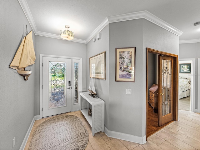 entrance foyer featuring baseboards and ornamental molding