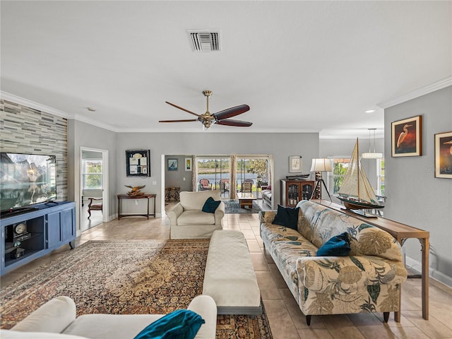 tiled living area featuring visible vents, plenty of natural light, and ornamental molding