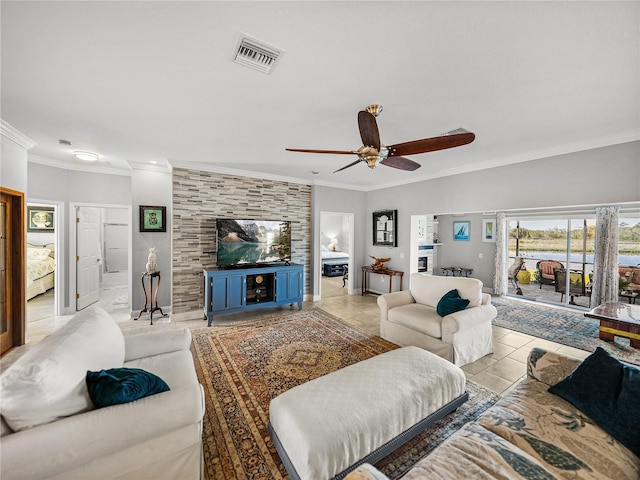 living area featuring crown molding, light tile patterned floors, a ceiling fan, and visible vents