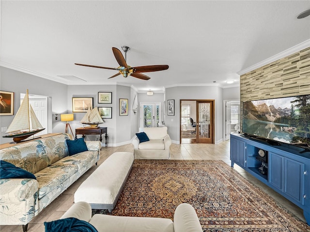 living room with visible vents, crown molding, baseboards, light tile patterned floors, and a ceiling fan