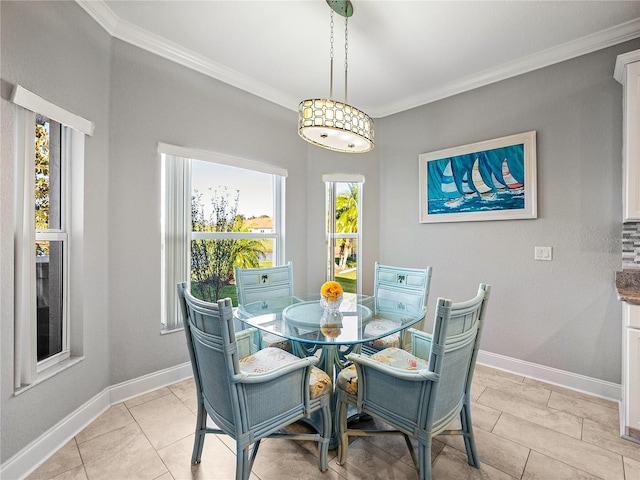 dining area with crown molding and baseboards