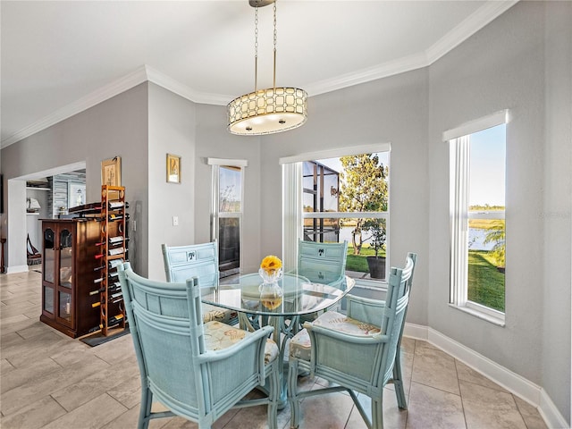 dining room with baseboards and crown molding