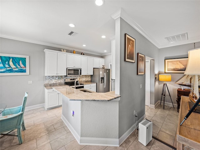 kitchen featuring a sink, visible vents, light stone counters, and appliances with stainless steel finishes