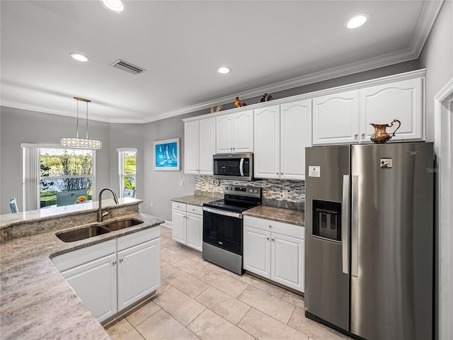 kitchen with visible vents, ornamental molding, appliances with stainless steel finishes, and a sink