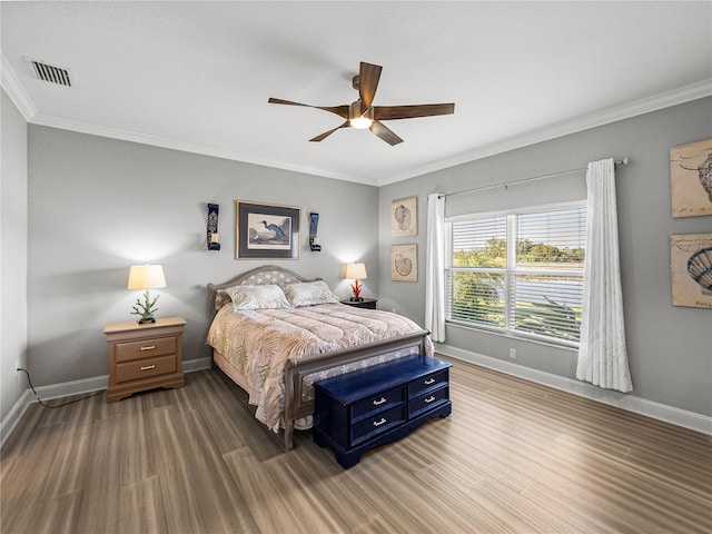 bedroom with crown molding, baseboards, and visible vents