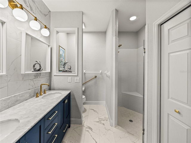 full bathroom featuring toilet, marble finish floor, a sink, tiled shower, and baseboards