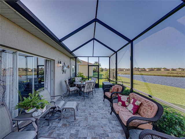 view of patio featuring a water view, a lanai, and an outdoor hangout area