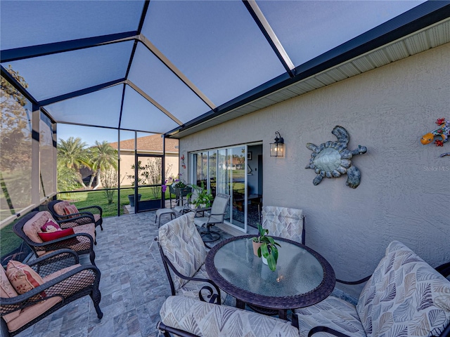 view of patio featuring glass enclosure and outdoor dining space