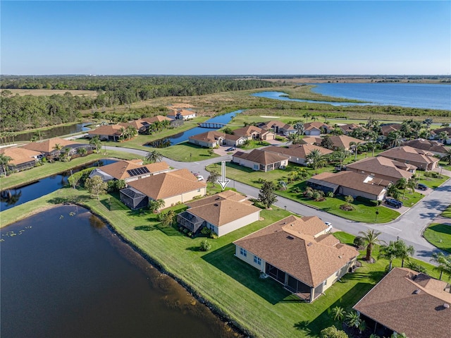 birds eye view of property featuring a water view and a residential view