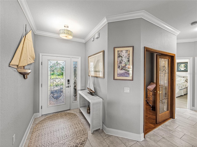 foyer entrance featuring baseboards and ornamental molding