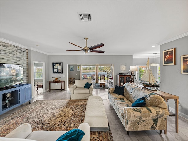 tiled living area with ceiling fan, baseboards, visible vents, and ornamental molding