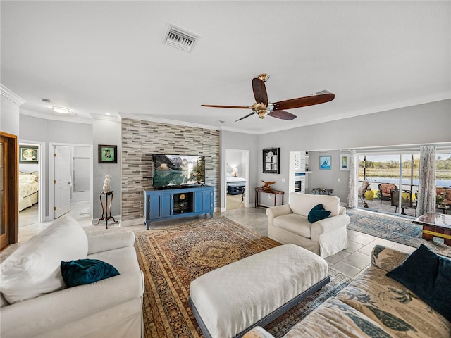 living area featuring crown molding, visible vents, tile patterned floors, and ceiling fan