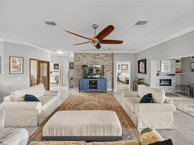 living area featuring visible vents, crown molding, ceiling fan, and a glass covered fireplace