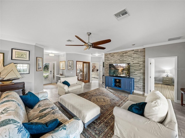 living room with visible vents, crown molding, and a ceiling fan