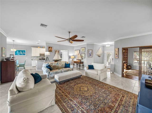 living area featuring a wealth of natural light, visible vents, and ornamental molding