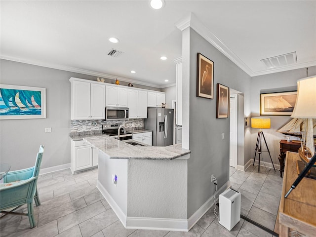 kitchen featuring light stone countertops, visible vents, appliances with stainless steel finishes, and a sink