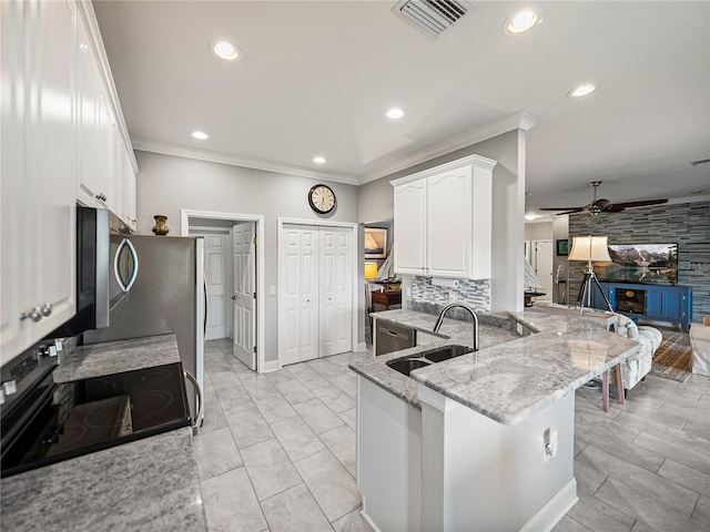 kitchen with visible vents, ceiling fan, a sink, appliances with stainless steel finishes, and white cabinetry