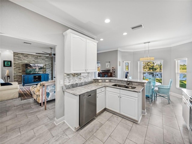 kitchen featuring light stone counters, visible vents, a sink, dishwasher, and crown molding