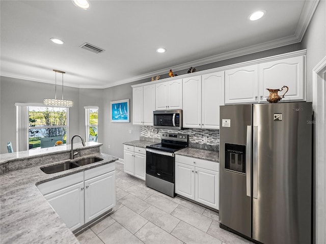 kitchen featuring visible vents, ornamental molding, a sink, white cabinetry, and stainless steel appliances