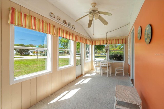 unfurnished sunroom with ceiling fan and vaulted ceiling