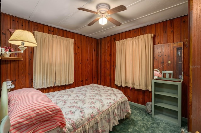 carpeted bedroom with wooden walls and a ceiling fan