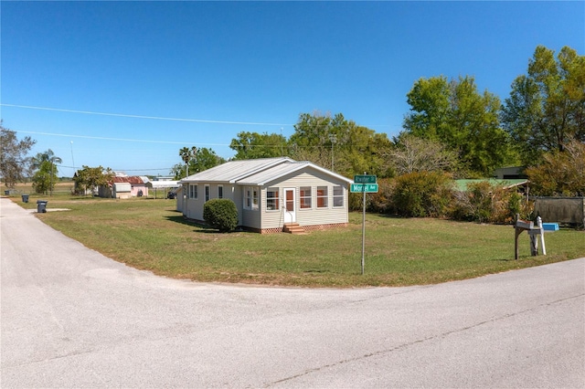 bungalow-style house with entry steps and a front yard