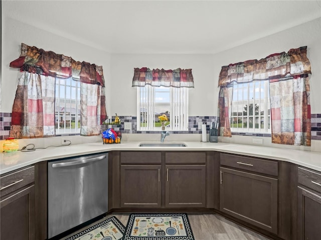 kitchen with a sink, dishwasher, and a healthy amount of sunlight