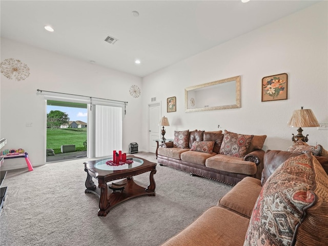 carpeted living area with recessed lighting and visible vents