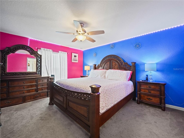 bedroom with carpet, ceiling fan, and a textured ceiling