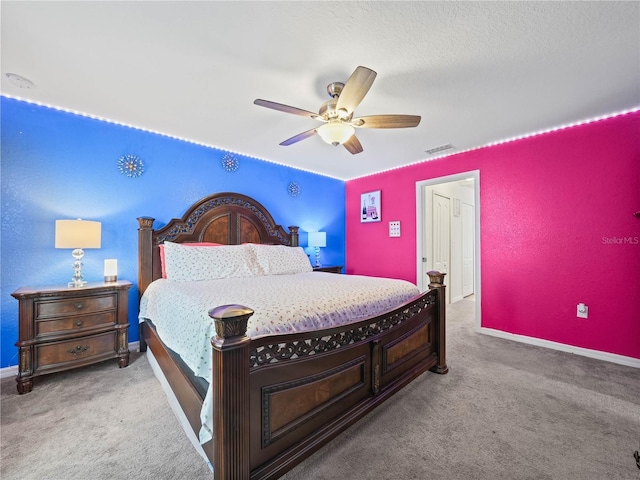 bedroom with visible vents, baseboards, ceiling fan, and carpet floors