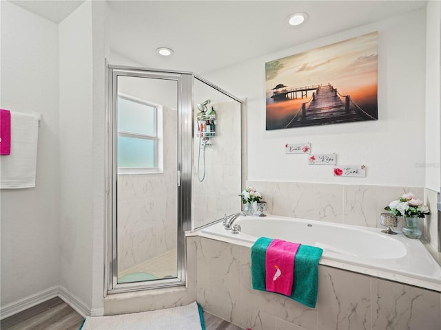 bathroom featuring a marble finish shower, baseboards, recessed lighting, wood finished floors, and a bath