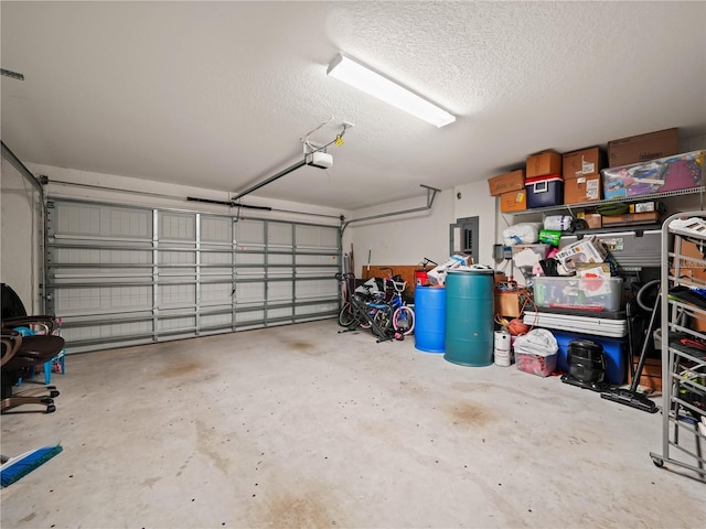 garage with electric panel and a garage door opener