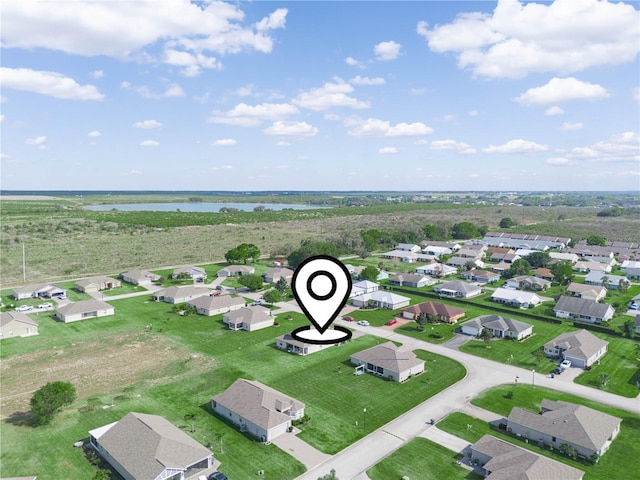 drone / aerial view featuring a residential view and a water view