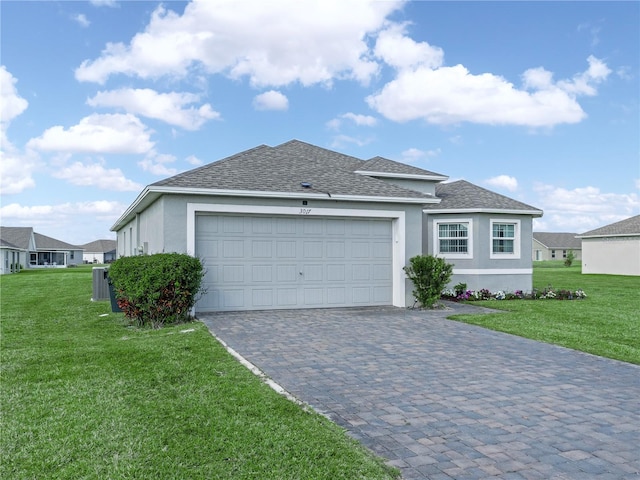 view of front facade featuring a front yard, decorative driveway, a garage, and stucco siding