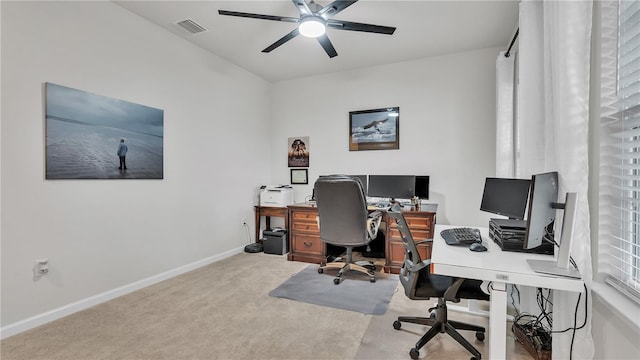 carpeted home office with visible vents, baseboards, and a ceiling fan