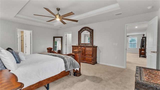 bedroom featuring visible vents, baseboards, ceiling fan, light carpet, and a raised ceiling