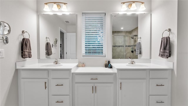 bathroom featuring a sink, visible vents, two vanities, and a shower stall