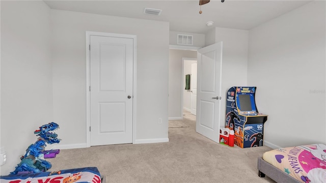 carpeted bedroom with visible vents and baseboards