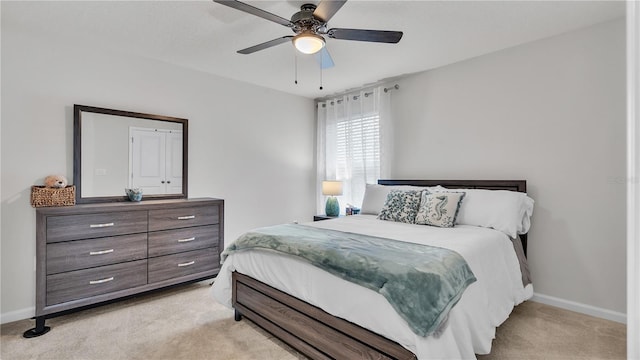 bedroom with baseboards, light carpet, and ceiling fan