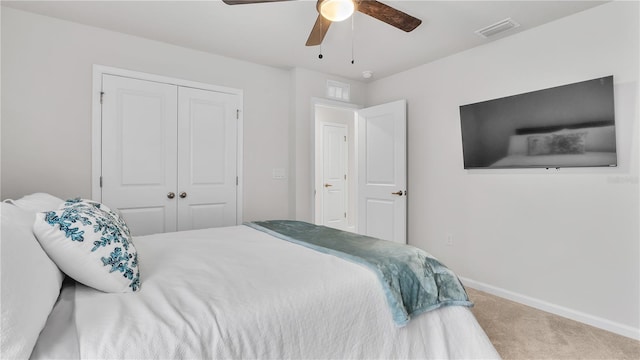 carpeted bedroom with a closet, visible vents, ceiling fan, and baseboards