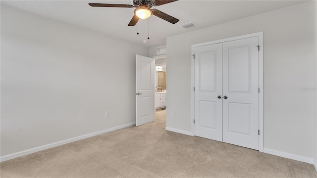 unfurnished bedroom with visible vents, ceiling fan, baseboards, light carpet, and a closet