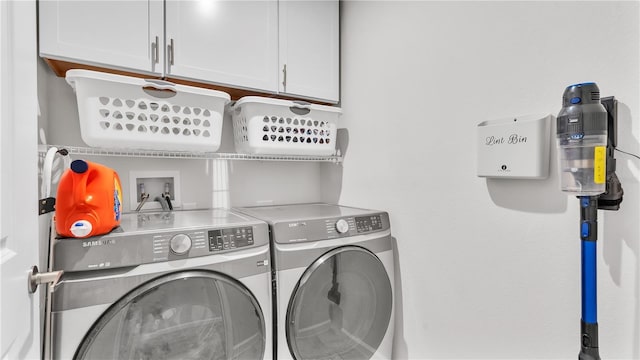 clothes washing area with cabinet space and separate washer and dryer