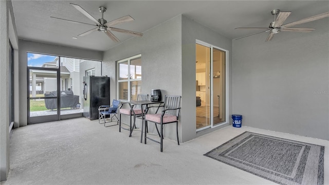 sunroom / solarium with a ceiling fan