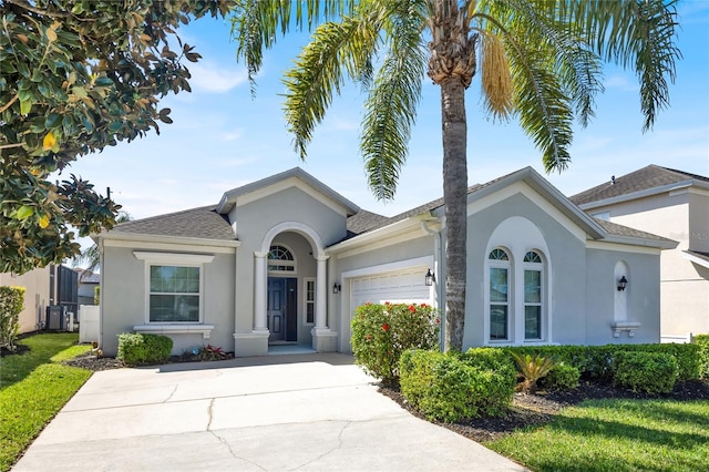 single story home featuring stucco siding, an attached garage, a shingled roof, and driveway