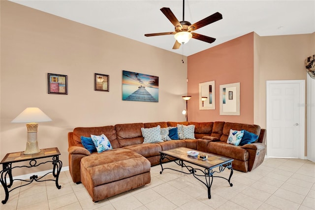 living area featuring light tile patterned floors, baseboards, and a ceiling fan