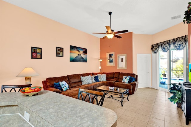 living area featuring light tile patterned flooring, visible vents, and ceiling fan