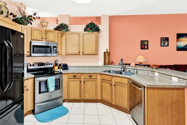 kitchen featuring light countertops, a peninsula, light tile patterned flooring, stainless steel appliances, and a sink