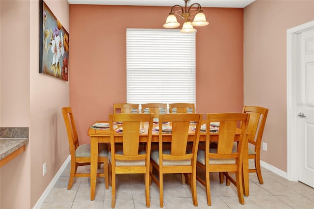 dining room featuring a healthy amount of sunlight, baseboards, and a chandelier