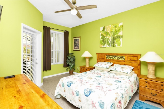 tiled bedroom with a ceiling fan and baseboards