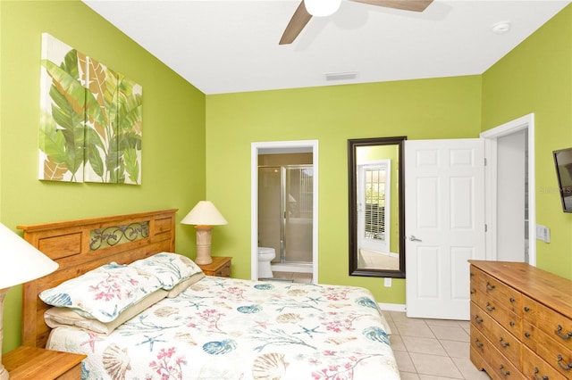 bedroom with light tile patterned floors, visible vents, ensuite bath, and ceiling fan